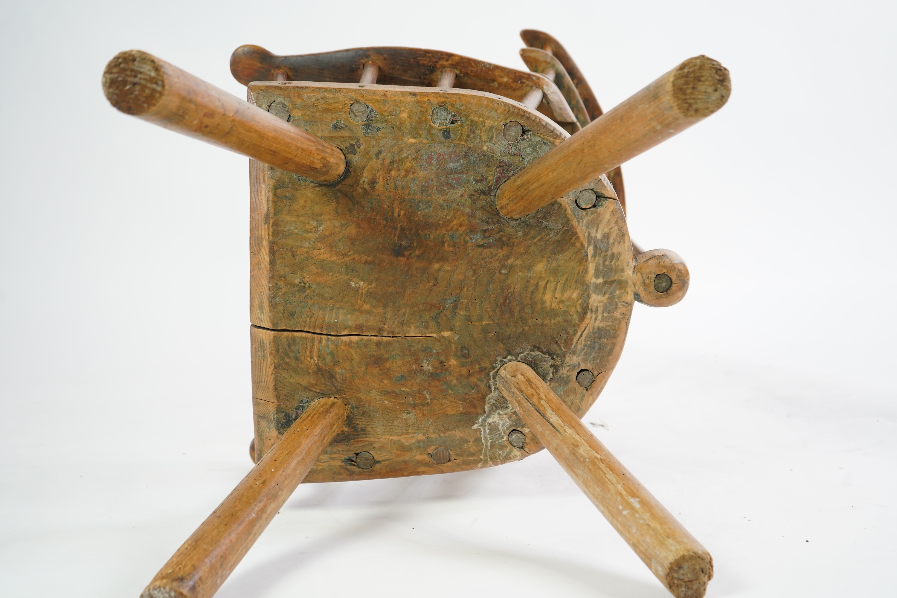 An 18th or 19th century primitive ash and elm Windsor armchair